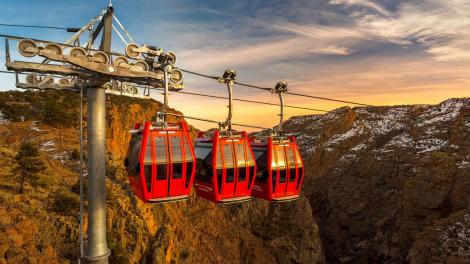 Gondolas gliding over Royal Gorge at sunset