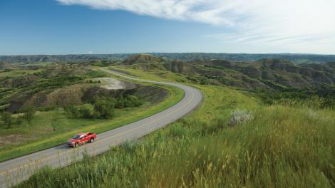 Driving along a rural road on a small- town road trip. 