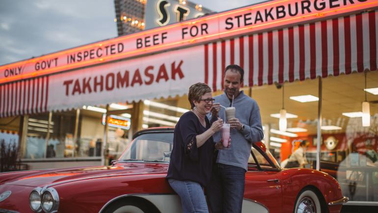 A couple enjoying classic milkshakes on Springfield's strech of Route 66
