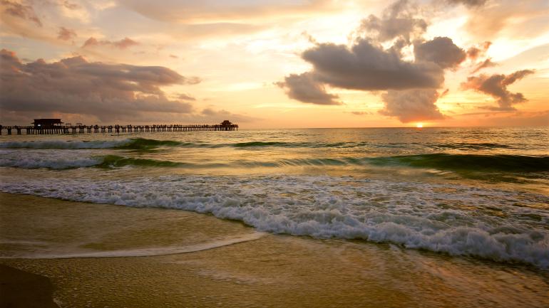 Setting sun over the Gulf of Mexico and a Naples-area beach
