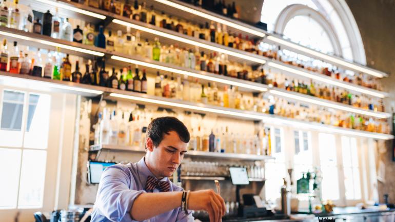 A bartender at STIR mixing a signature cocktail 
