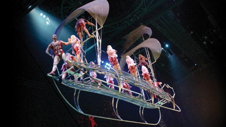 O barco de estrutura de aço flutua sobre as águas, oferecendo uma plataforma para a exibição de acrobacias exclusivas.