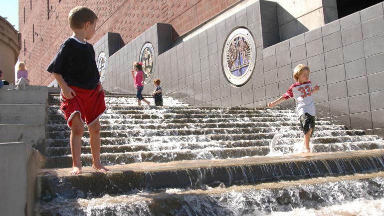 Kids dipping their feet in The Passage, an interactive Trail of Tears memorial