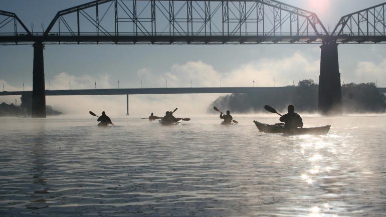 A group of kayakers set off along the river in Chattanooga