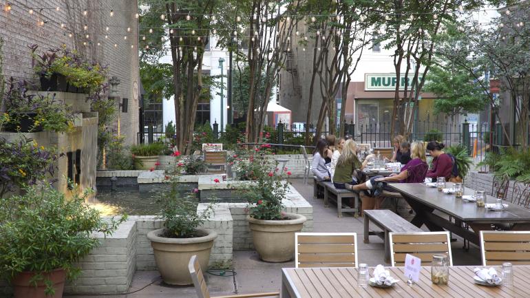 Patio dining in a garden-like setting at Felicia Suzanne's