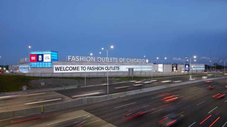 Signage welcoming shoppers to the Fashion Outlets of Chicago