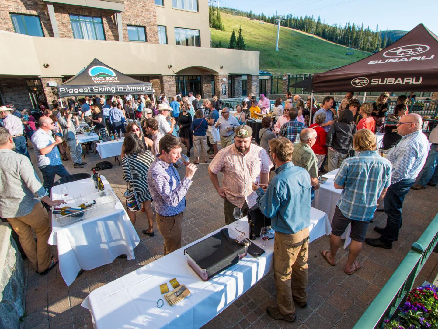 An outdoor wine tasting event during Vine and Dine in Big Sky, Montana