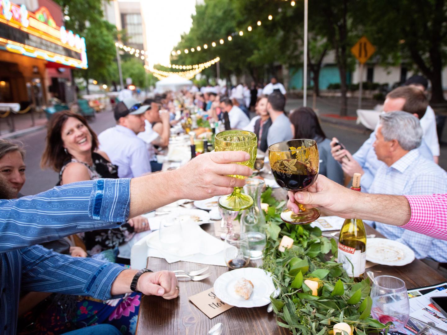 Dining on Stockton’s Main Street at a long outdoor table during the farm-to-table Feast at the Fox event