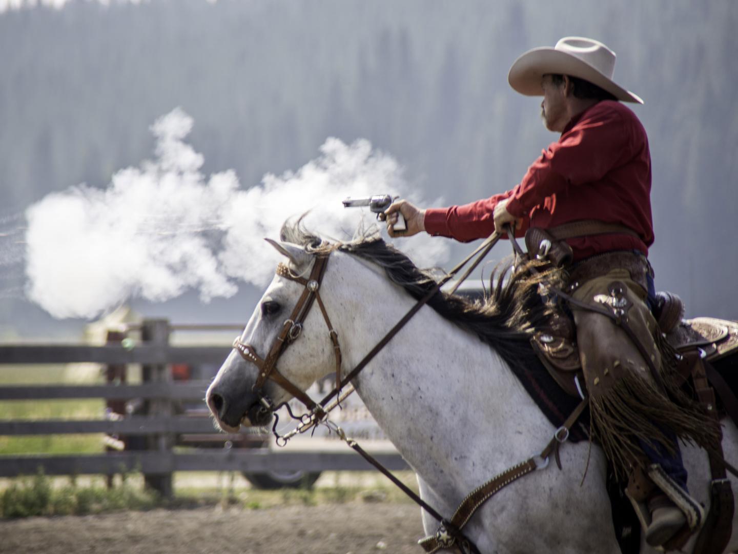 A cowboy in the Diamond P Cowboy Mounted Shooting Competition in West Yellowstone, Montana