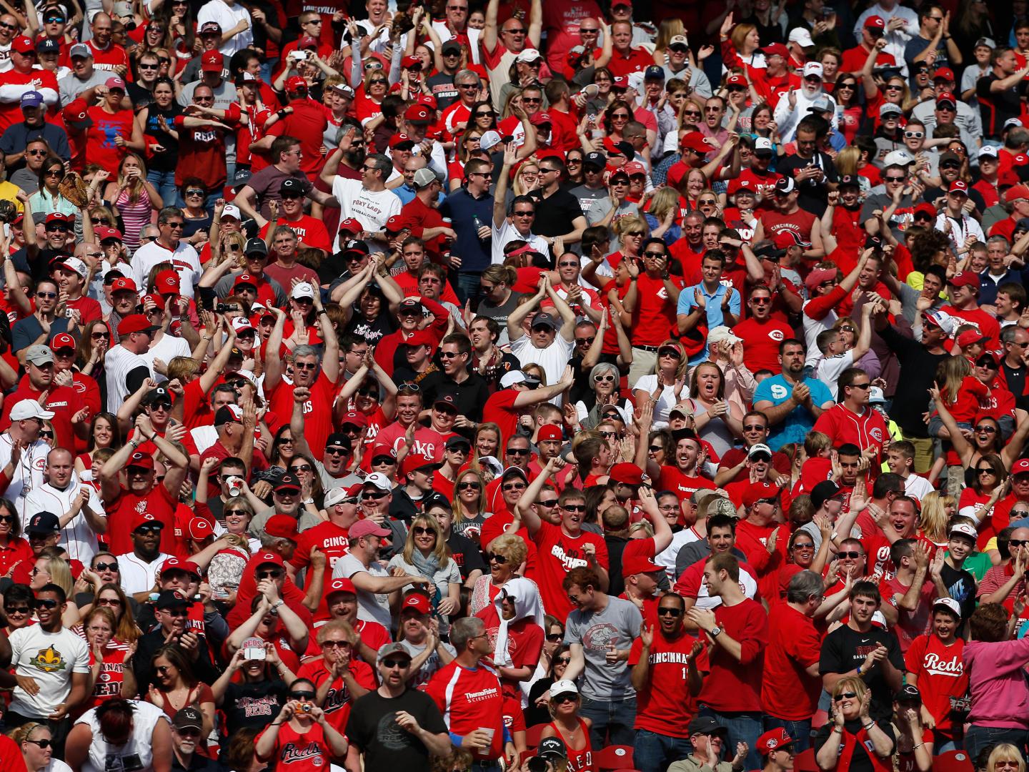Large group of Cincinnati fans cheering on a new season of Reds baseball in Cincinnati, Ohio