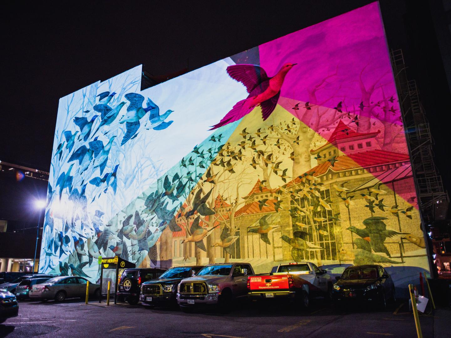 Lights illuminate a mural at night during the BLINK art festival in Cincinnati, Ohio