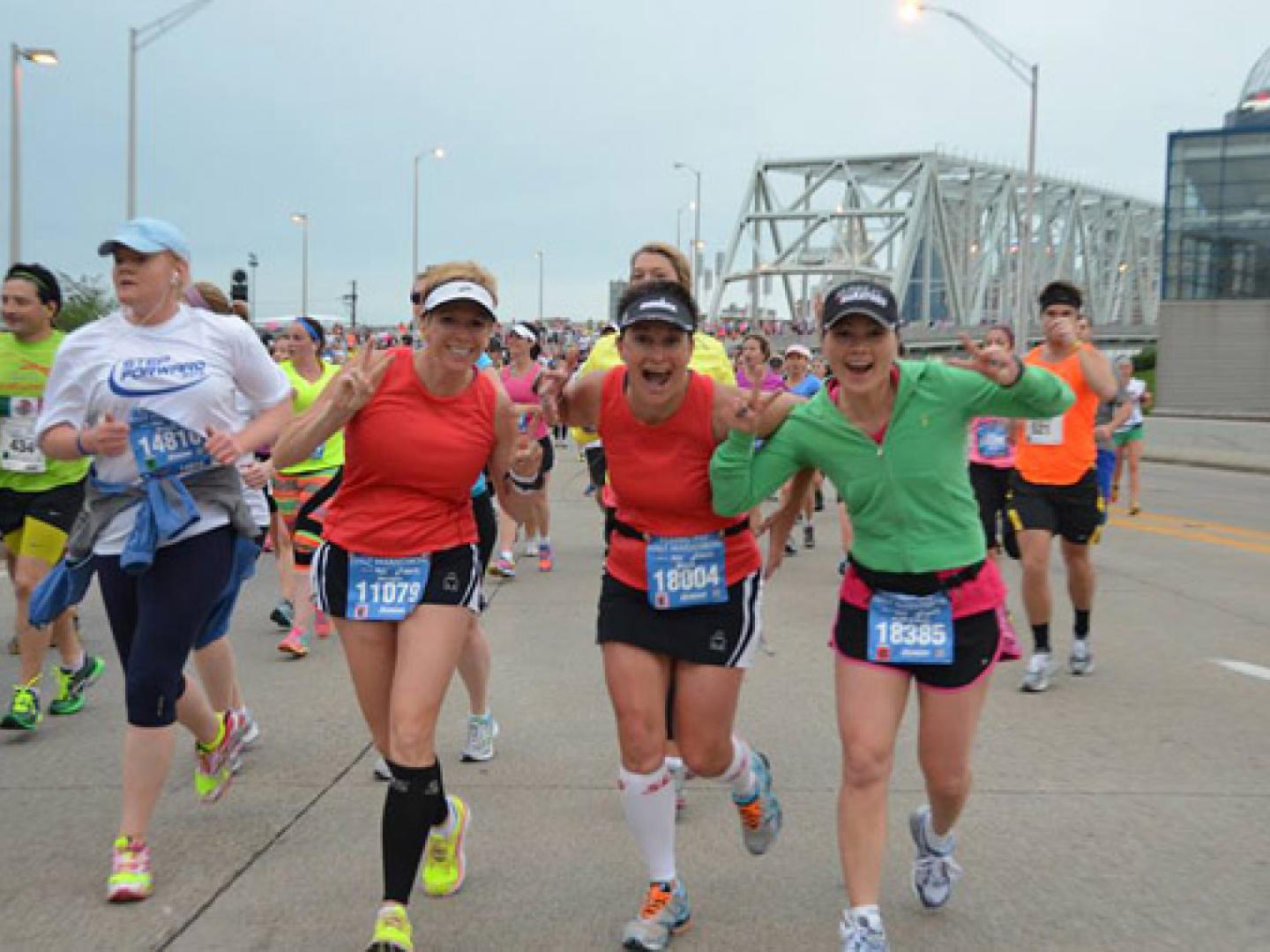 Runners saying hello while starting their marathon through Cincinnati, Ohio