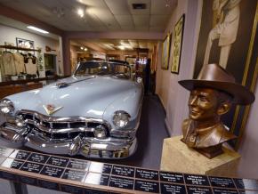A bust of the Country musician and his blue Cadillac at the Hank Williams Museum