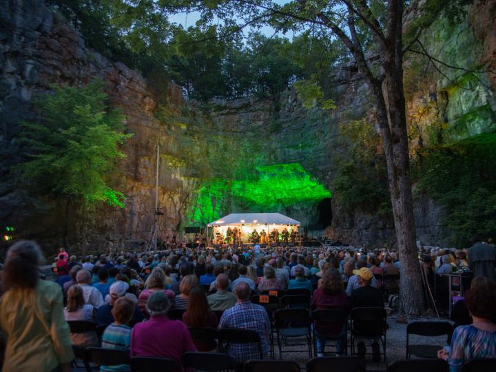 A live music performance in a cave during the Three Caves Concert Series in Huntsville, Alabama