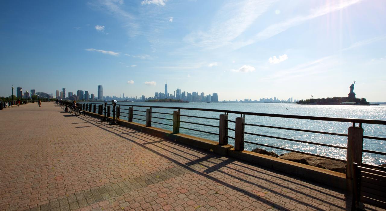 Liberty State Park boardwalk overlooks the iconic Manhattan skyline in Jersey City, New Jersey.