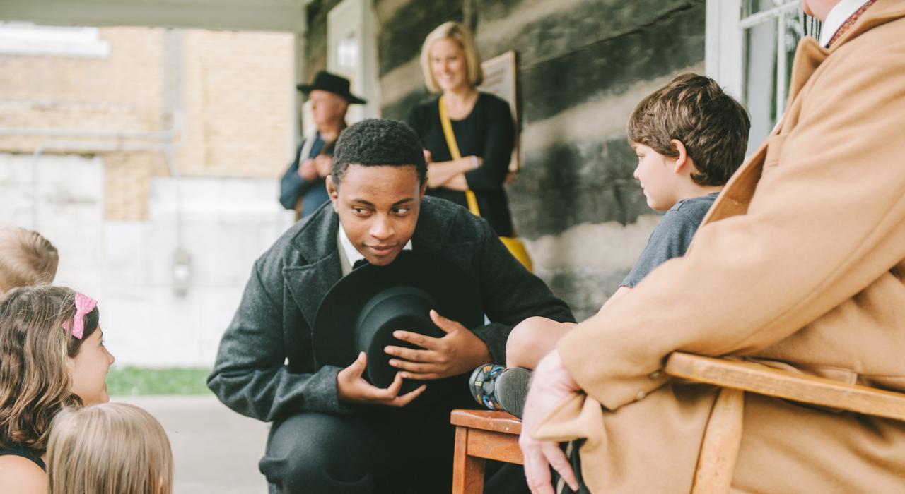 A courthouse reenactor greets kids in Independence Square