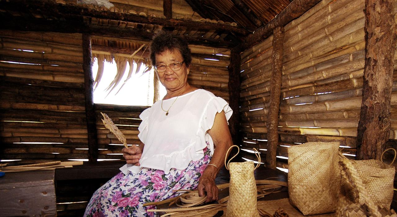 A weaver displays her finished items